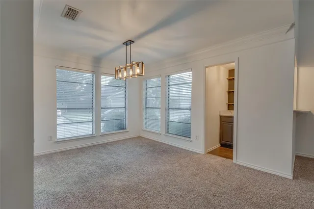 a view of a chandelier in a room and kitchen view