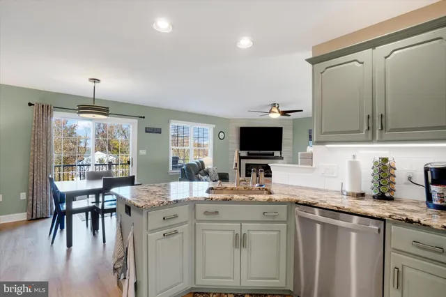 a kitchen with stainless steel appliances a sink stove and cabinets