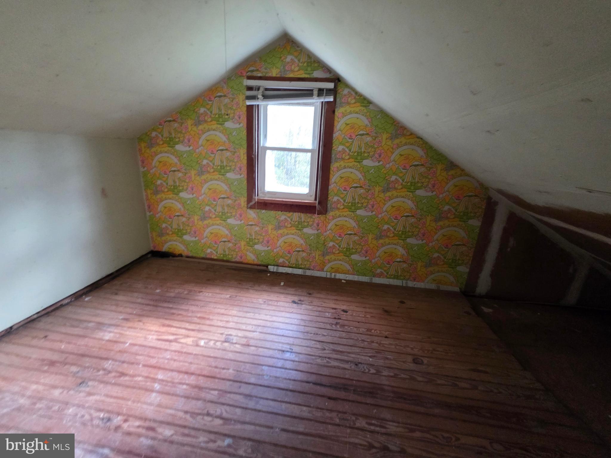 24984 Forrest Cove Way Hollywood, MD 20636 - Photo 6 of 10 a view of an empty room with wooden floor and a window