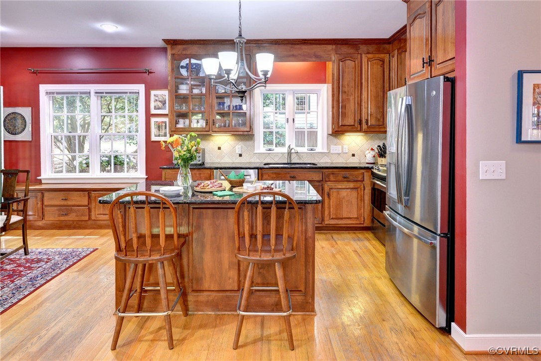 7 Hague Close Williamsburg, VA 23185 - Photo 21 of 50 a kitchen with stainless steel appliances granite countertop a table chairs and a refrigerator