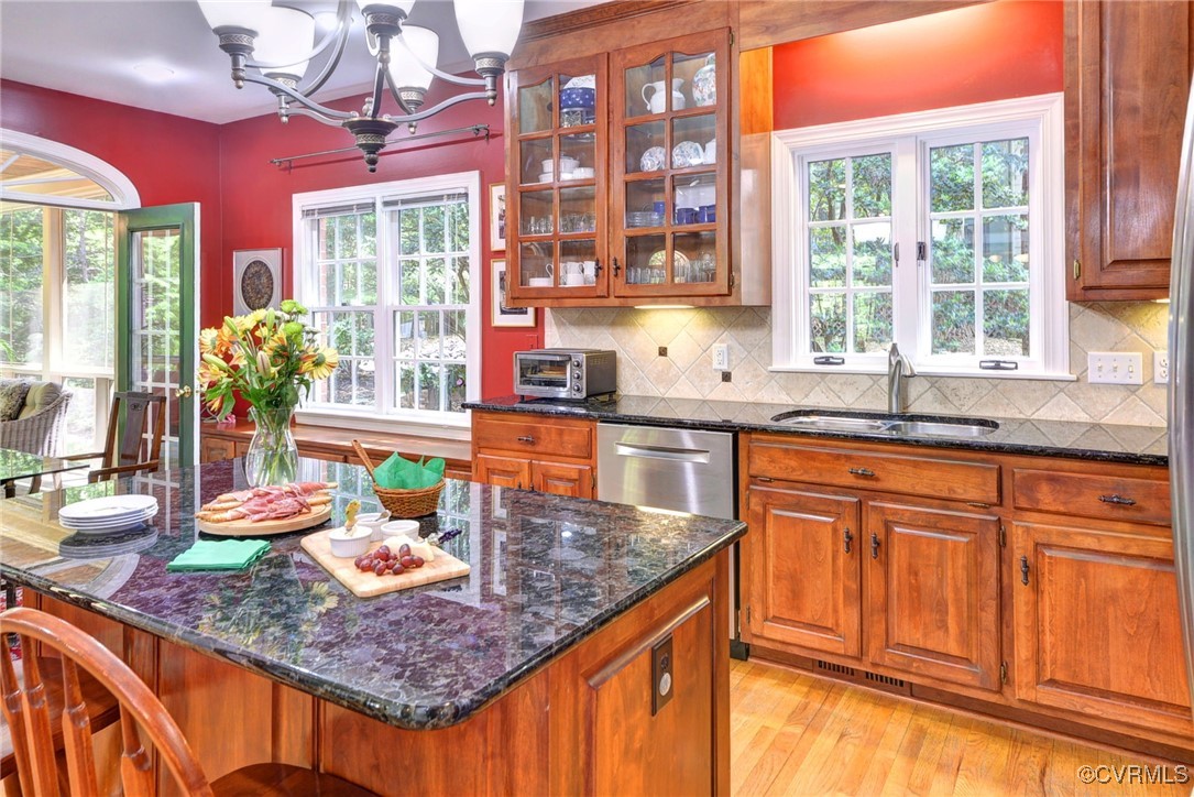 7 Hague Close Williamsburg, VA 23185 - Photo 22 of 50 a kitchen with stainless steel appliances granite countertop a sink a stove and a wooden cabinets