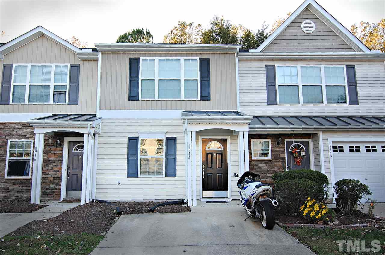 a front view of a house with outdoor seating
