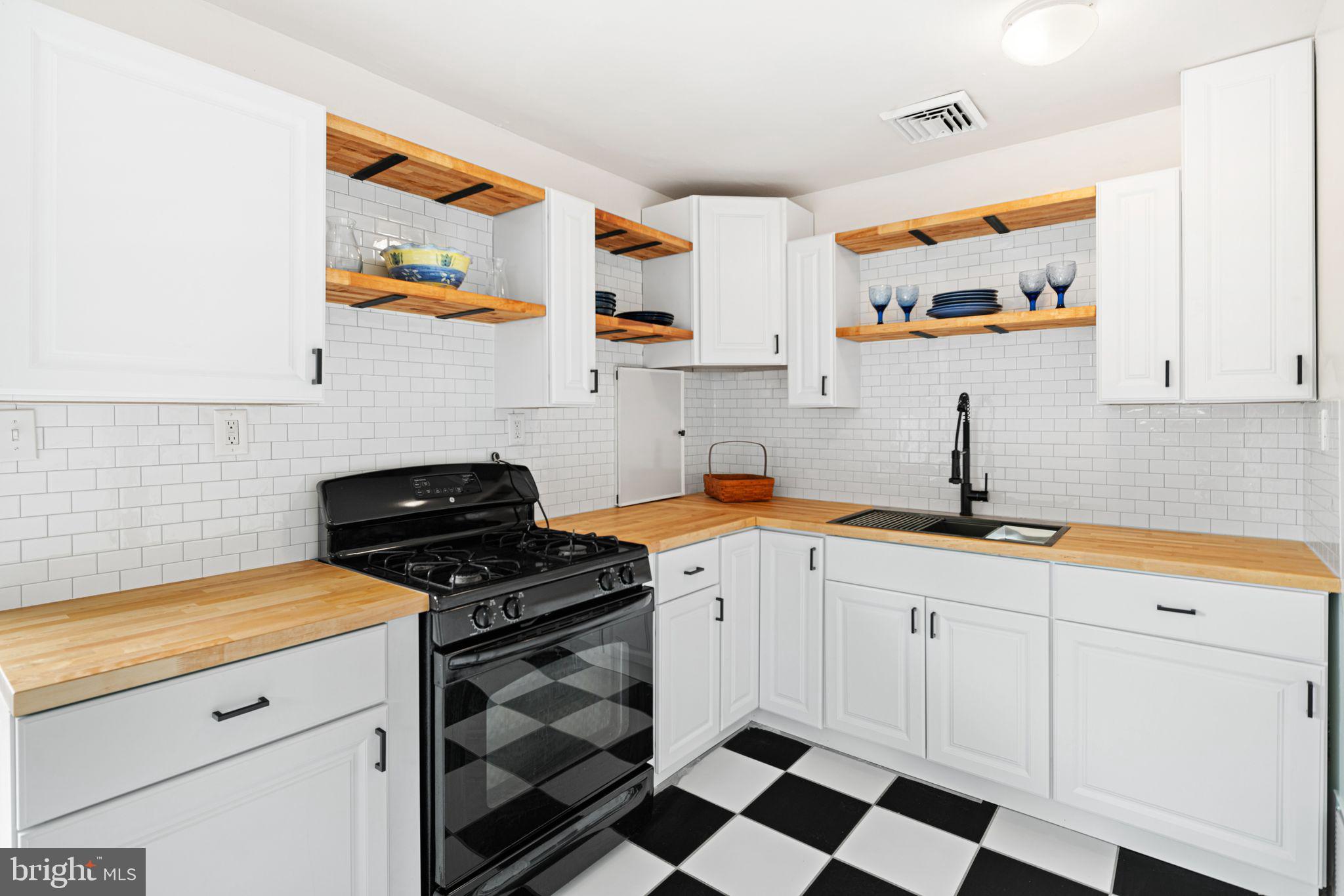906 Stephen Avenue Croydon, PA 19021 - Photo 6 of 20 a kitchen with a sink a stove and cabinets