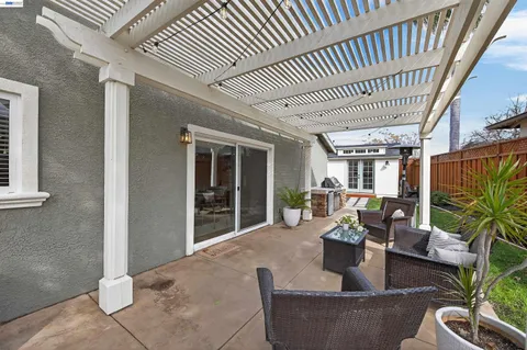 a view of a patio with couches table and chairs and potted plants