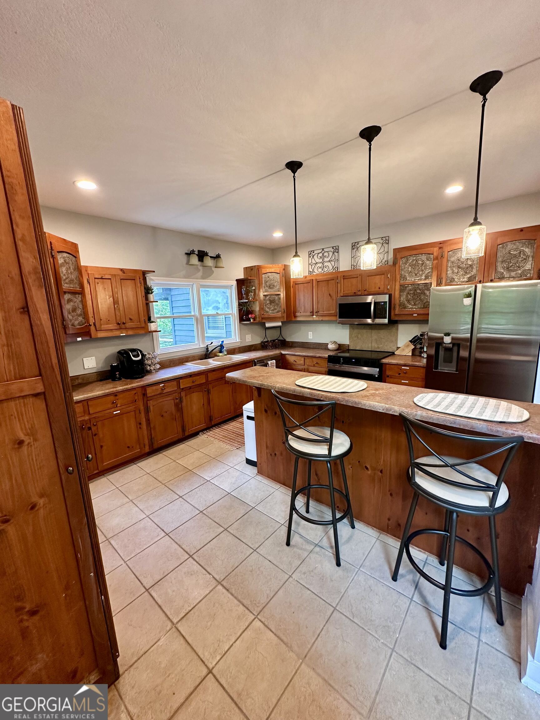 2769 Bean Creek Road Sautee Nacoochee, GA 30571 - Photo 14 of 33 a kitchen with stainless steel appliances kitchen island granite countertop a stove a sink and a refrigerator