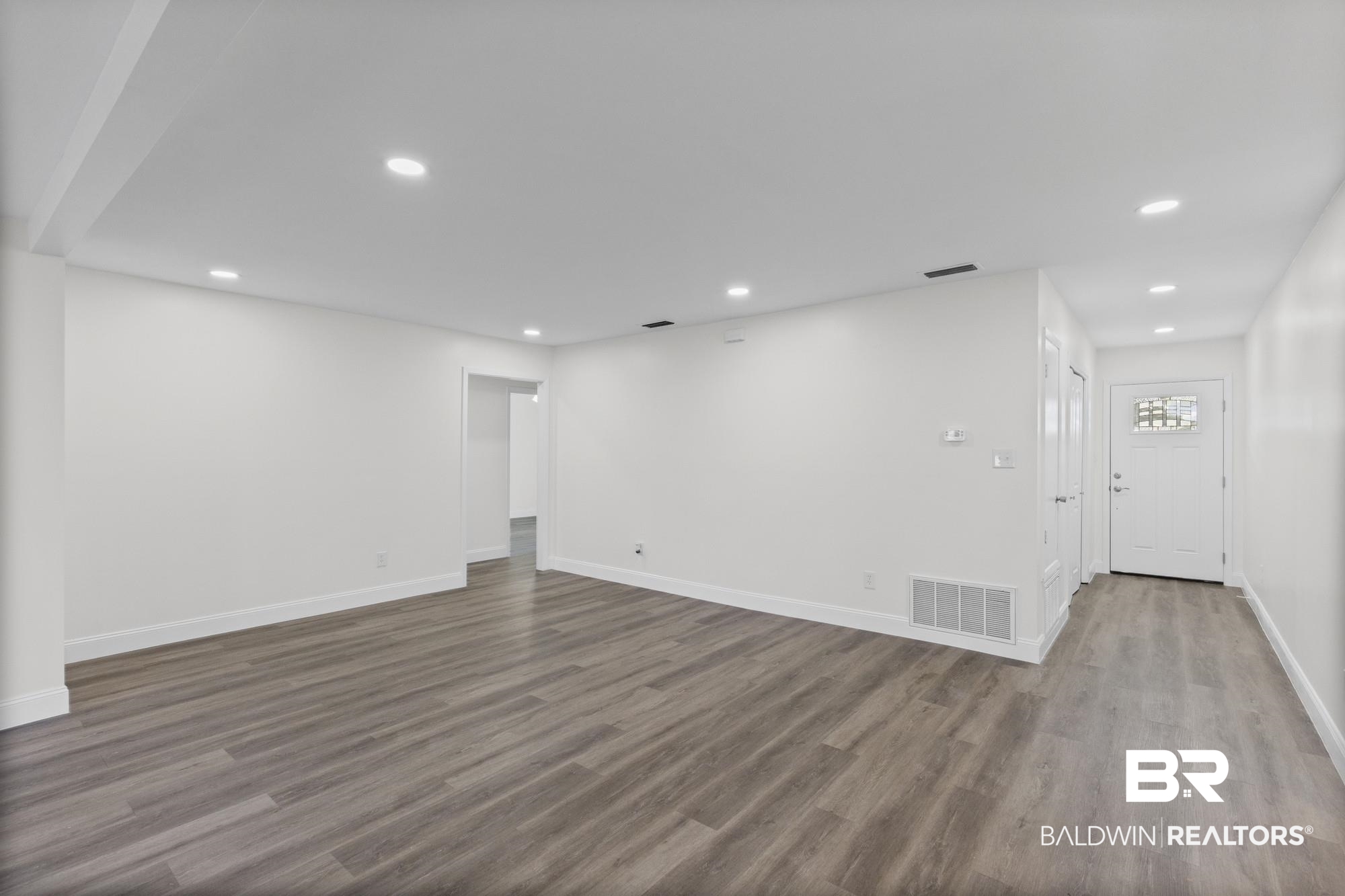 3041 Pretty Branch Drive East Mobile, AL 36618 - Photo 4 of 20 Unfurnished living room featuring recessed lighting and dark wood-style flooring