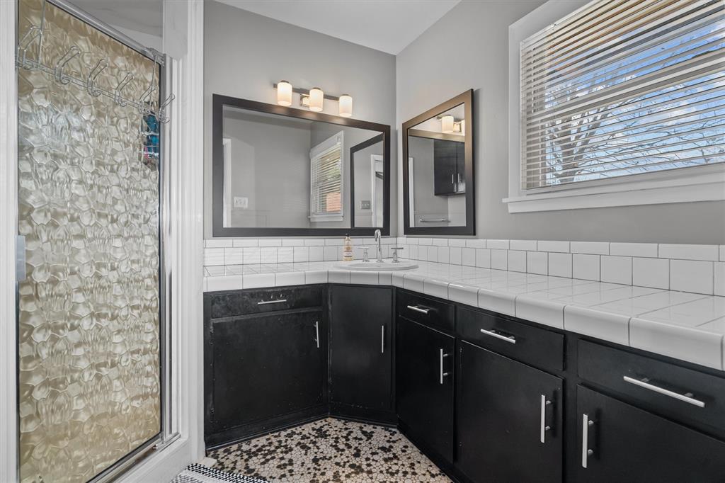 2526 Pounds Avenue Tyler, TX 75701 - Photo 22 of 25 a bathroom with a sink a vanity and a mirror