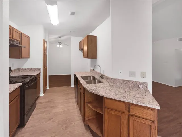 a kitchen with a sink and a stove top oven