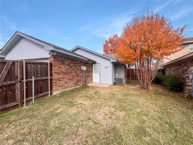 a view of a house with a yard and garage
