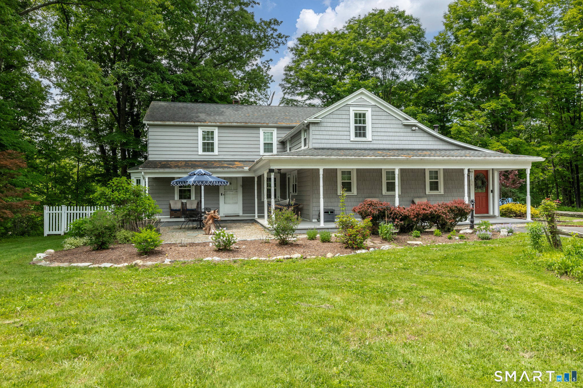 808 Branch Road Suffield, CT 06078 - Photo 3 of 40 a front view of house with a garden and patio