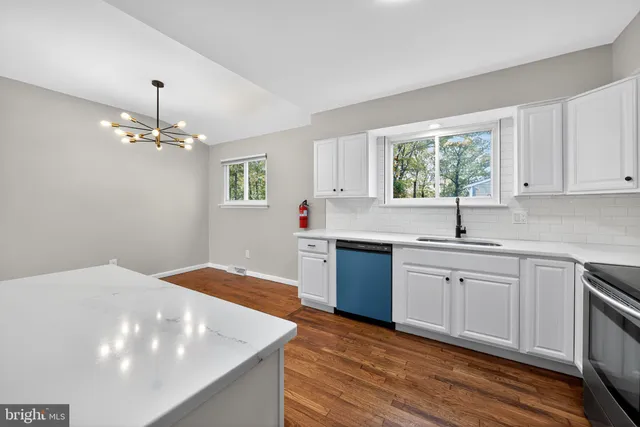 a kitchen with a sink stove and cabinets
