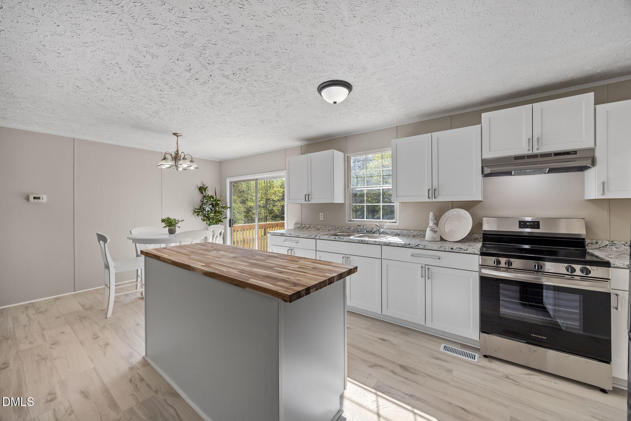721 General Green Road Kittrell, NC 27544 - Photo 12 of 36 a kitchen with stainless steel appliances granite countertop a stove a sink dishwasher and a refrigerator with wooden floor