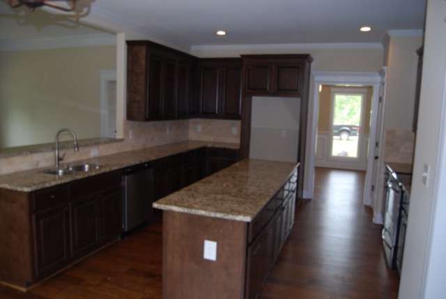 92 Carters Way Forsyth, GA 31029 - Photo 12 of 21 a kitchen with stainless steel appliances granite countertop a sink a stove and a refrigerator