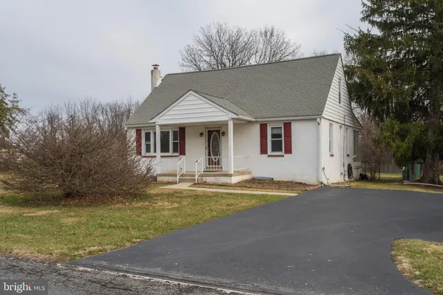 a front view of a house with swimming pool and porch