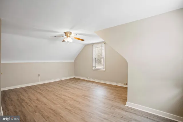 a view of a room with wooden floor and white walls