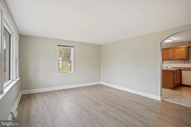 a view of a room with wooden floor and electronic appliances