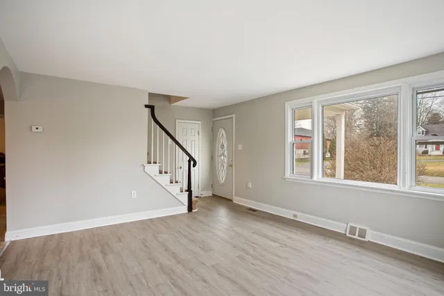 a view of an entryway with wooden floor