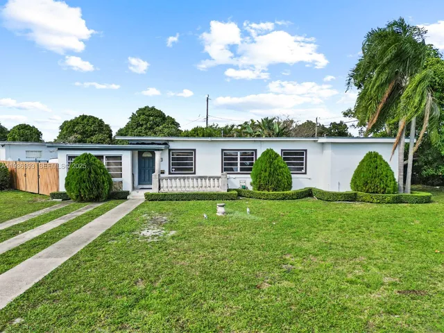 a view of a house with a backyard and a patio