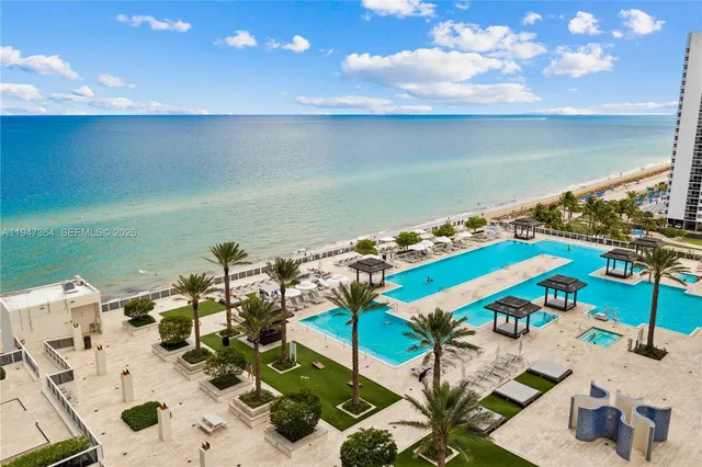 view of an ocean and a floor to ceiling window