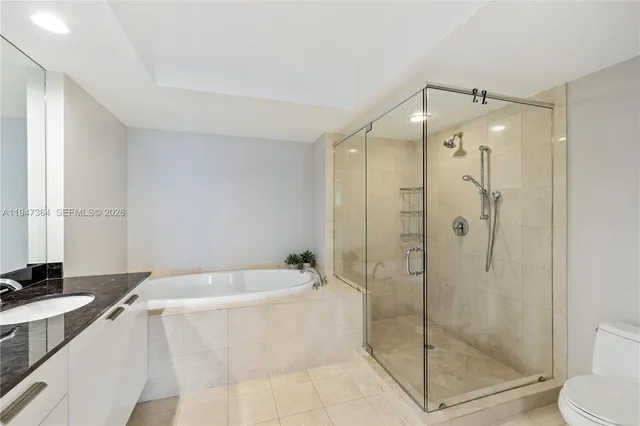 a bathroom with a bathtub shower sink and toilet