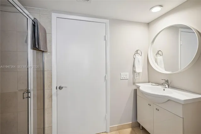 a bathroom with a sink mirror and vanity
