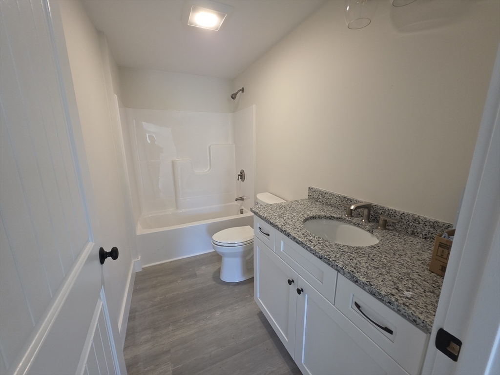 87 Acapesket Road, Unit 2A Falmouth, MA 02536 - Photo 10 of 17 a bathroom with a granite countertop sink and a mirror