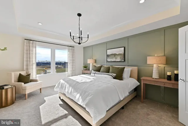 a large bedroom with a bed and large window