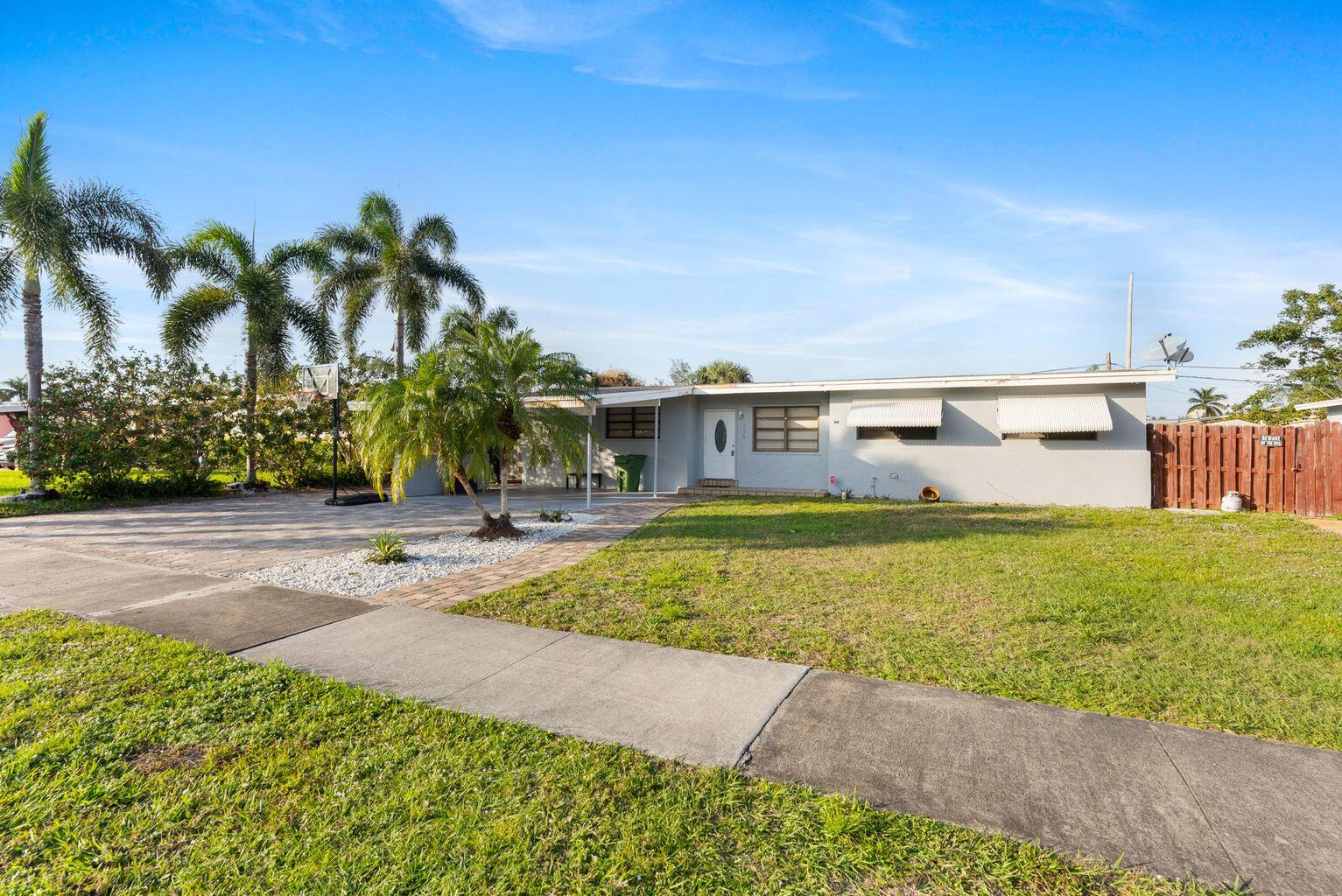 336 Ponte Vedra Road Palm Springs, FL 33461 - Photo 1 of 16 a view of swimming pool with a garden and seating area