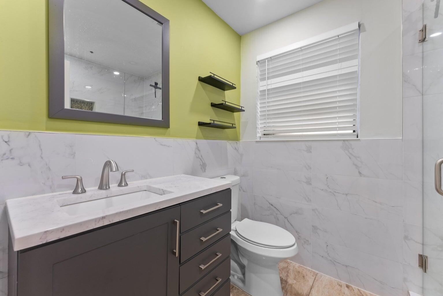 336 Ponte Vedra Road Palm Springs, FL 33461 - Photo 13 of 16 a bathroom with a sink toilet and mirror