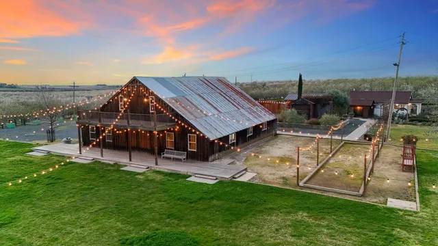 an aerial view of a house with a big yard