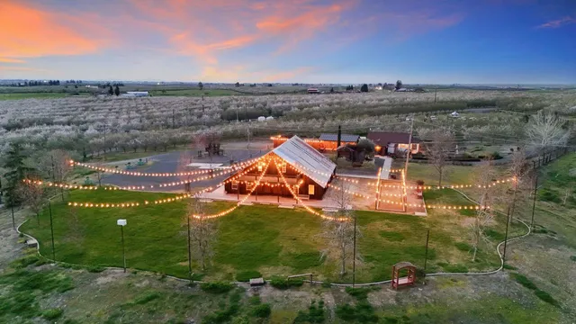 a view of a back yard with an empty space and wooden fence