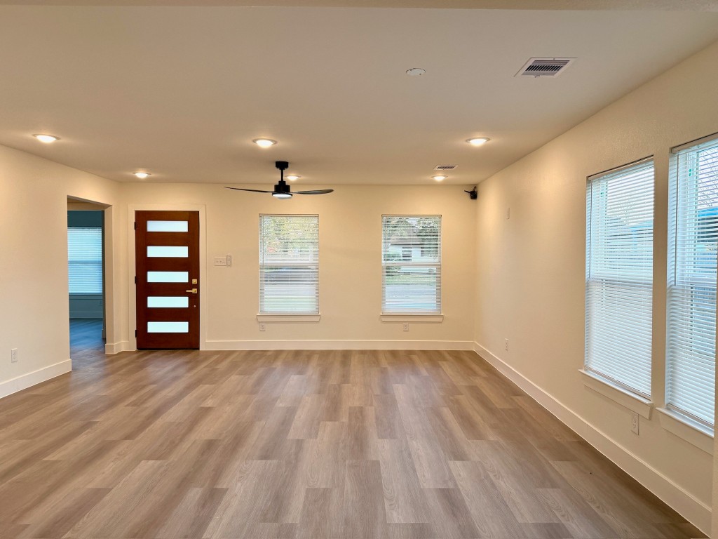 512 Morrell Street Baytown, TX 77520 - Photo 15 of 19 a view of an empty room with a window and wooden floor