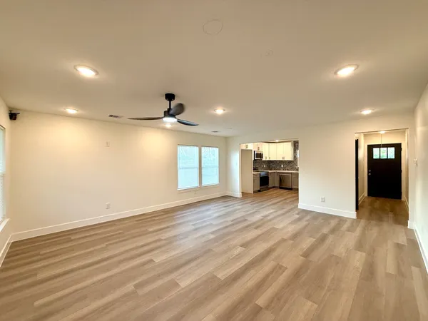 a view of empty room with wooden floor