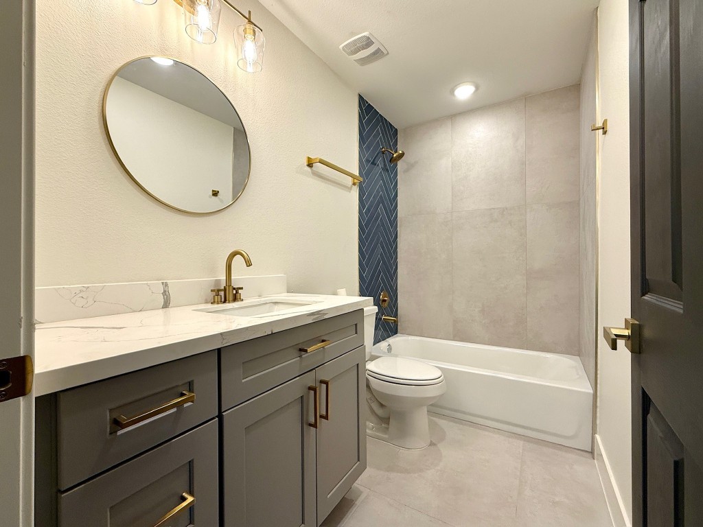 512 Morrell Street Baytown, TX 77520 - Photo 2 of 19 a bathroom with a sink a toilet and a mirror