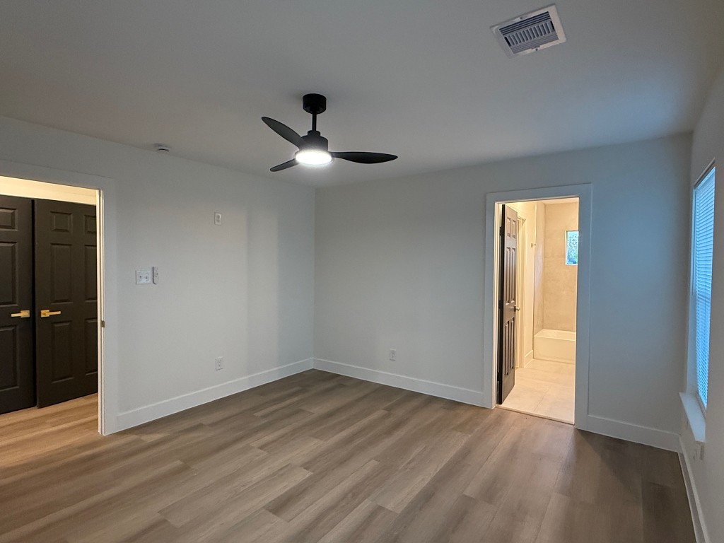 512 Morrell Street Baytown, TX 77520 - Photo 10 of 19 a view of empty room with wooden floor and fan