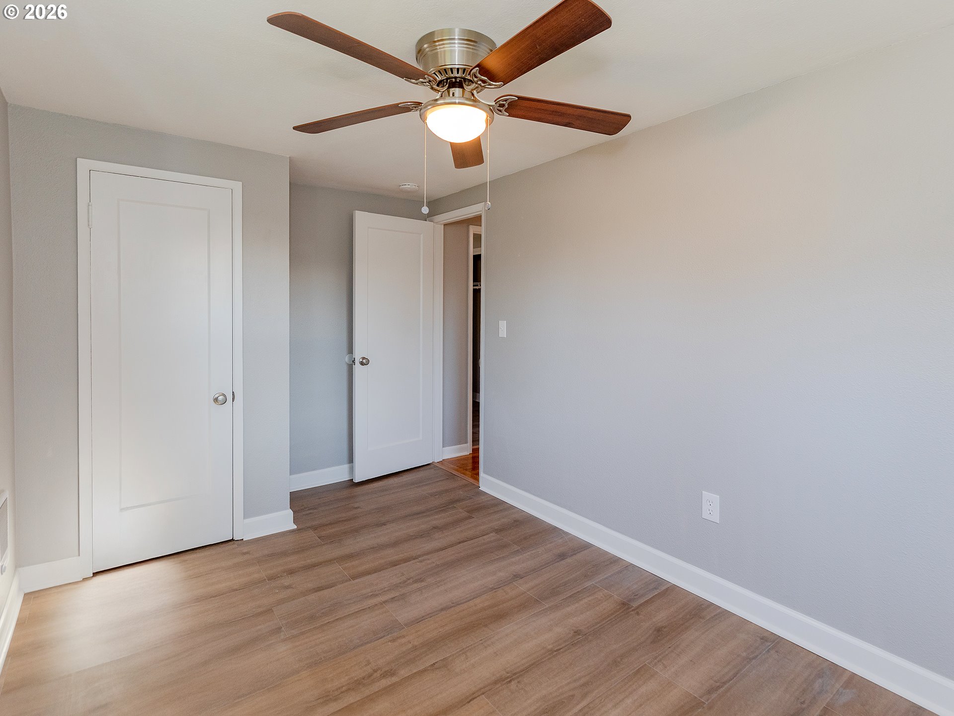 904 East 33rd Street Vancouver, WA 98663 - Photo 23 of 26 an empty room with wooden floor fan and windows