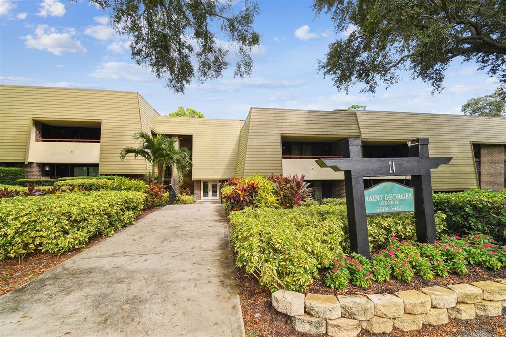 36750 US Highway 19 North, Unit 24211 Palm Harbor, FL 34683 - Photo 1 of 54 a front view of a house with a garden