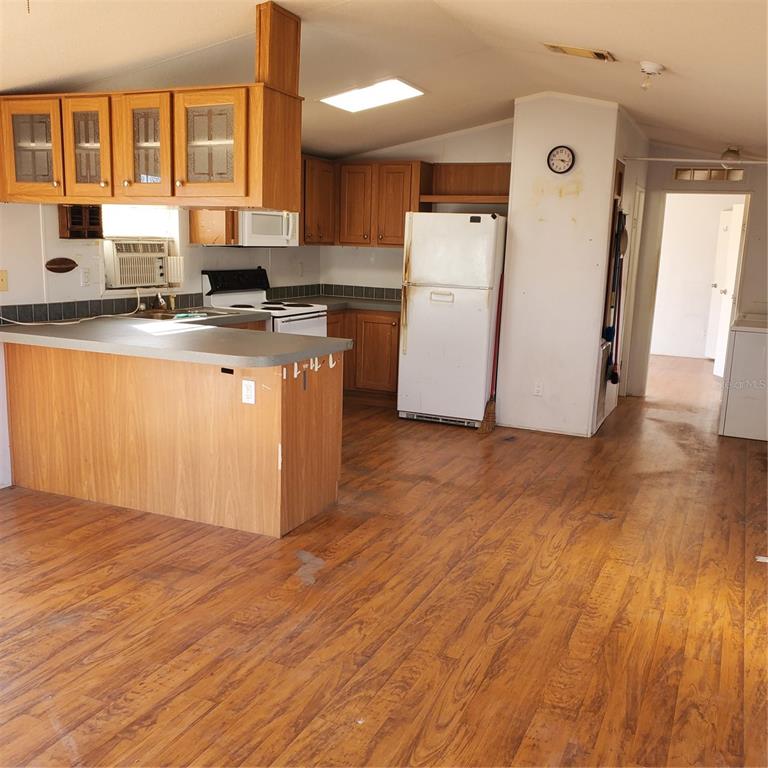 2926 Sharon Road Groveland, FL 34736 - Photo 12 of 16 a kitchen with refrigerator and white cabinets