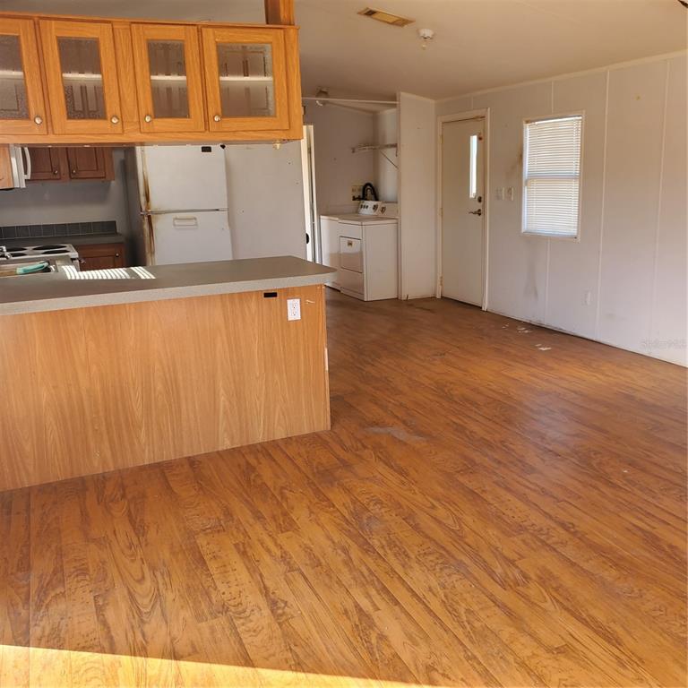 2926 Sharon Road Groveland, FL 34736 - Photo 8 of 16 a view of a kitchen with wooden floor and cabinets
