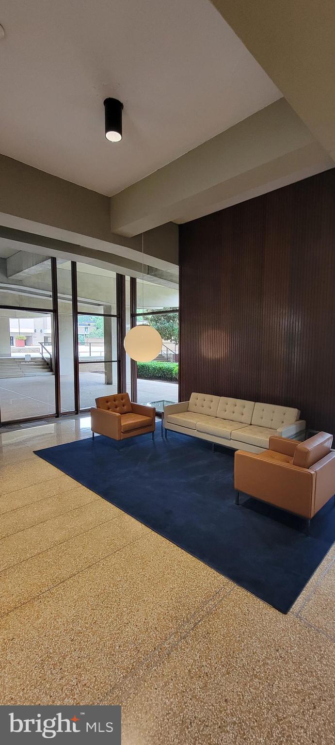 490 M Street Southwest, Unit W101 Washington, DC 20024 - Photo 18 of 19 a living room with furniture and a floor to ceiling window