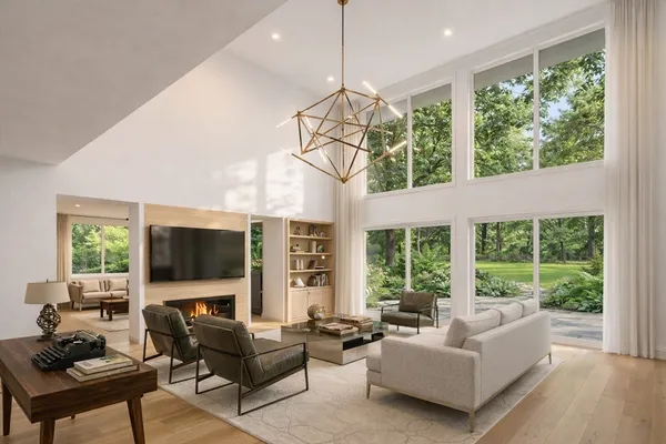 a living room with furniture a flat screen tv and a large window