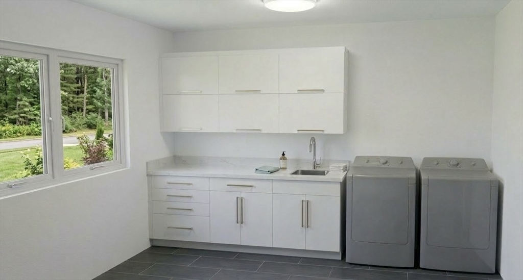 18 Annawan Road Newton, MA 02468 - Photo 6 of 7 a utility room with cabinets washer and dryer