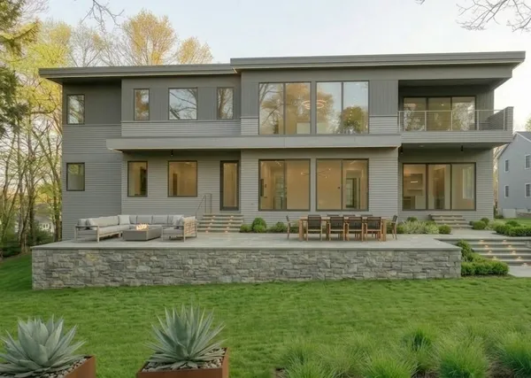a front view of a house with a garden