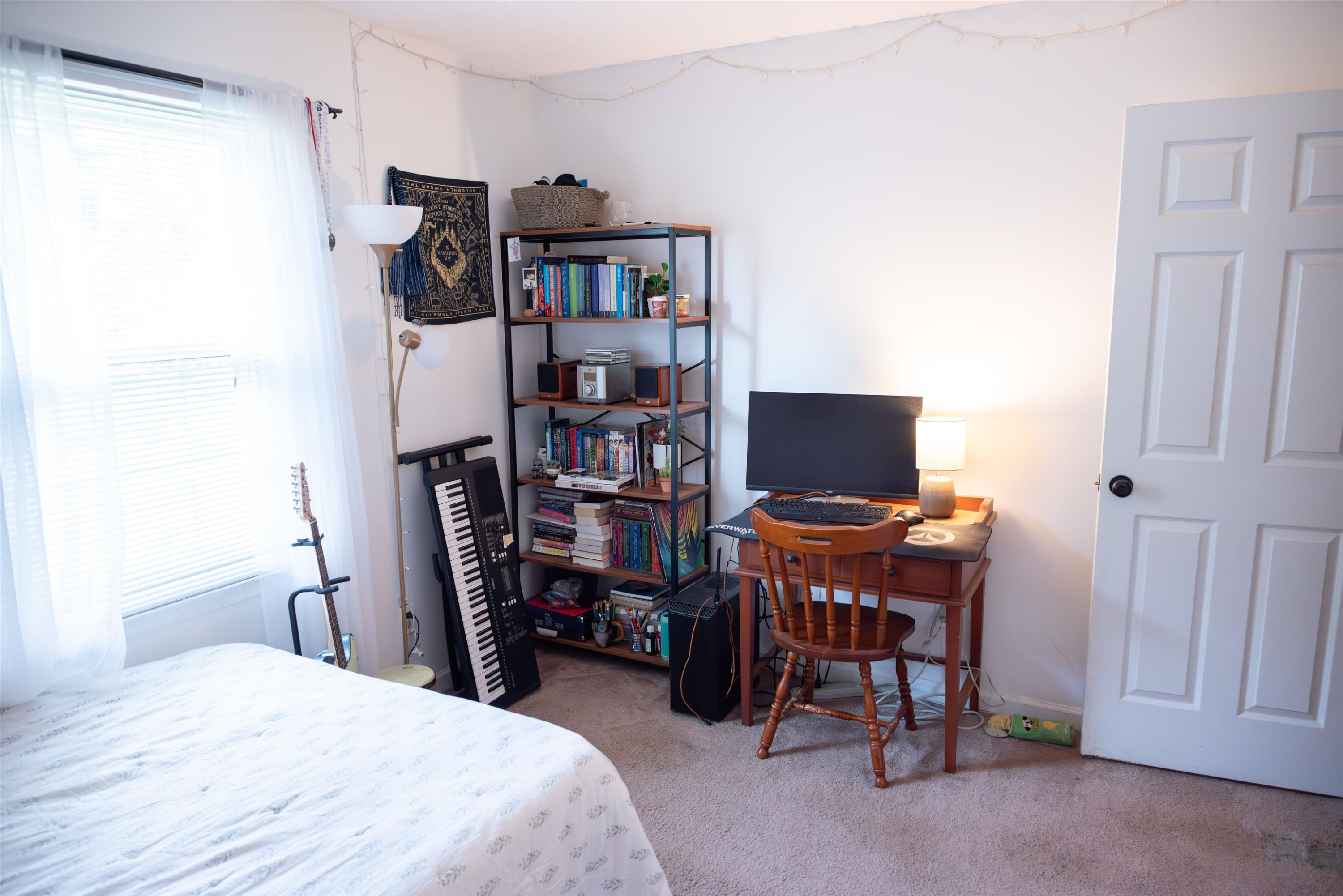1301 Buckhorn Road Garner, NC 27529 - Photo 14 of 24 a bedroom with a bed and a bookshelf