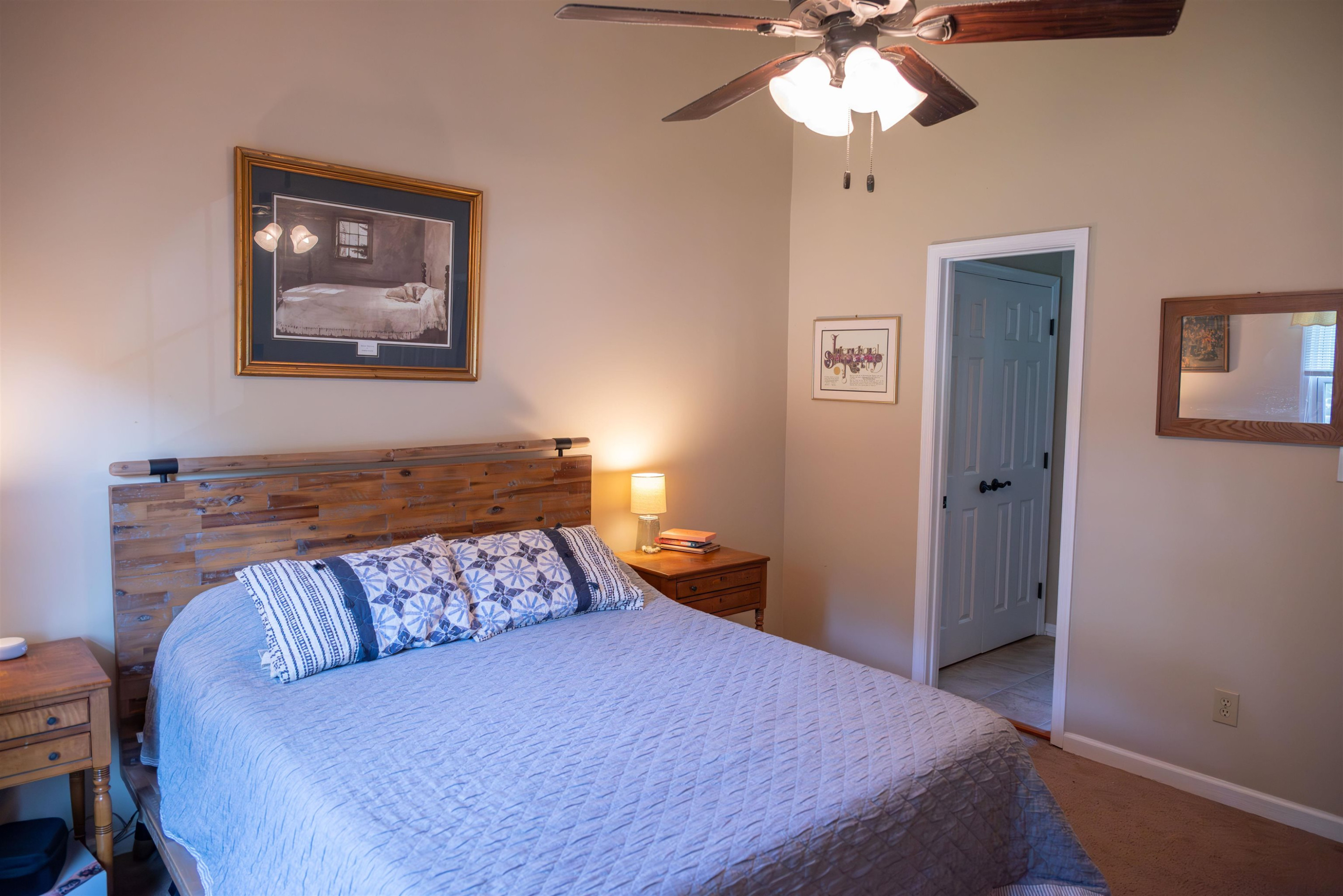 1301 Buckhorn Road Garner, NC 27529 - Photo 19 of 24 a bedroom with a bed and a chandelier