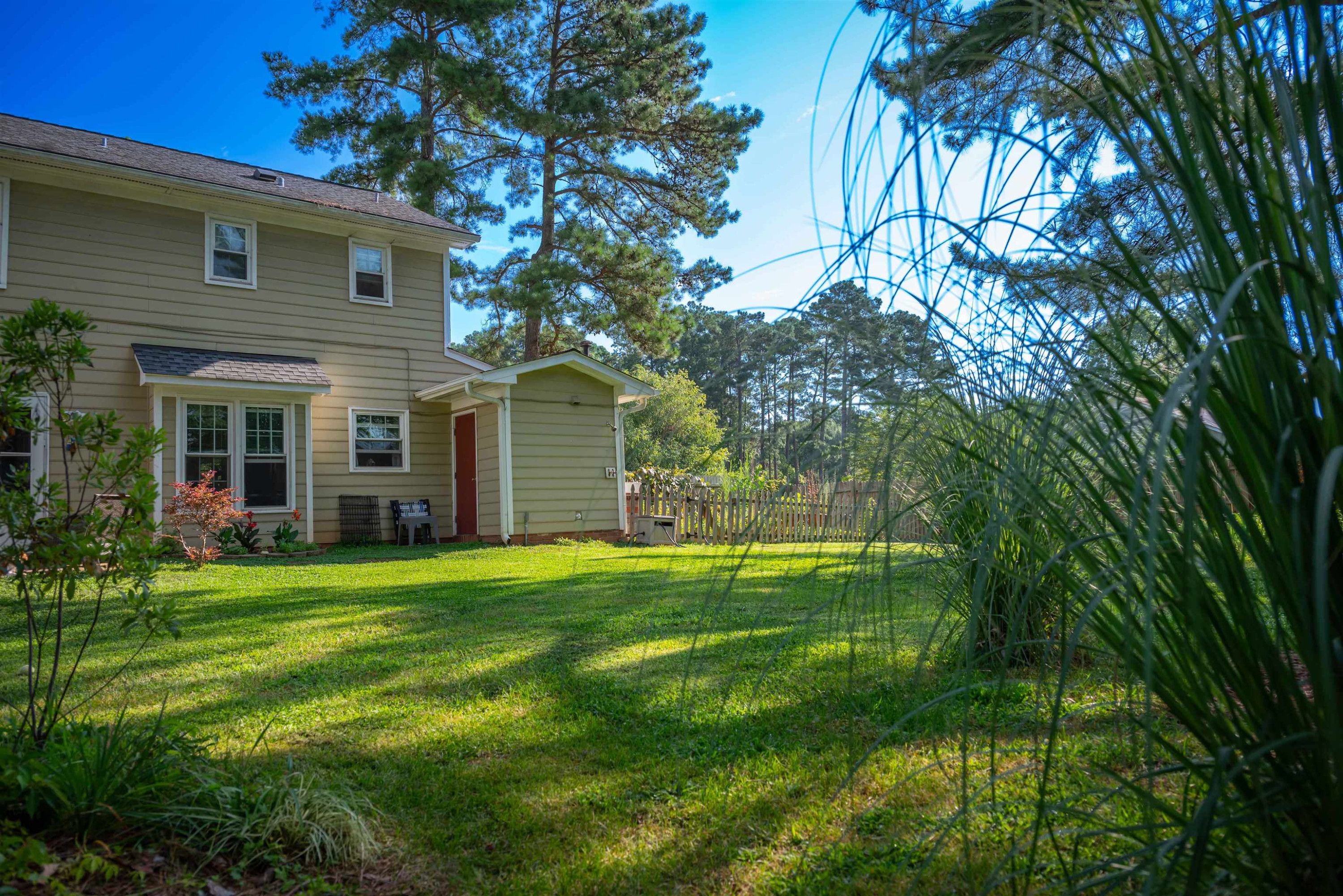 1301 Buckhorn Road Garner, NC 27529 - Photo 24 of 24 a backyard of a house with plants and large tree
