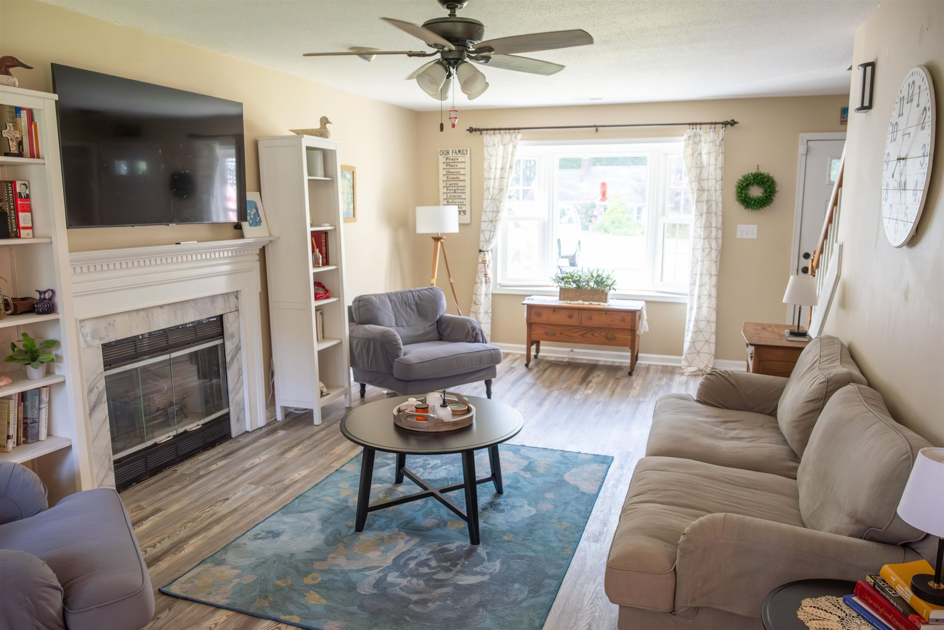 1301 Buckhorn Road Garner, NC 27529 - Photo 6 of 24 a living room with furniture a flat screen tv and a fireplace