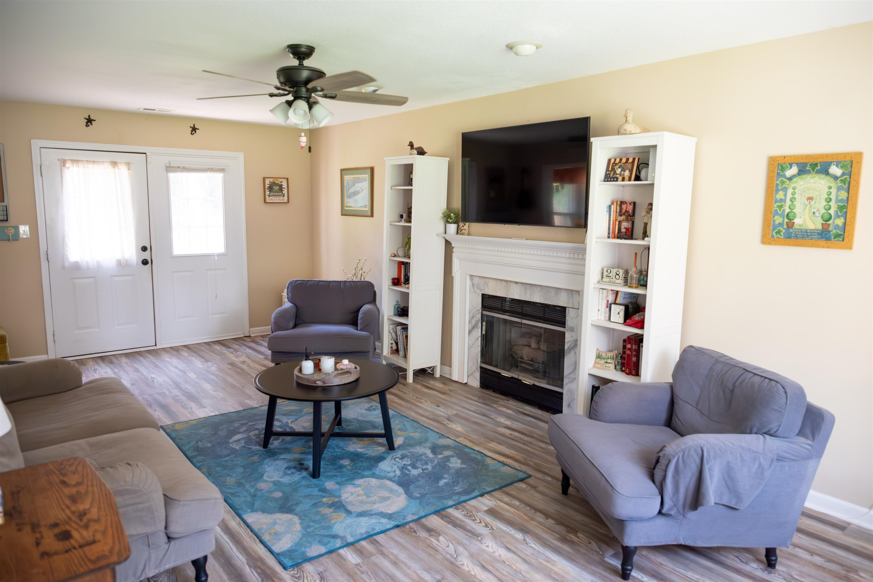 1301 Buckhorn Road Garner, NC 27529 - Photo 7 of 24 a living room with furniture a fireplace and a flat screen tv