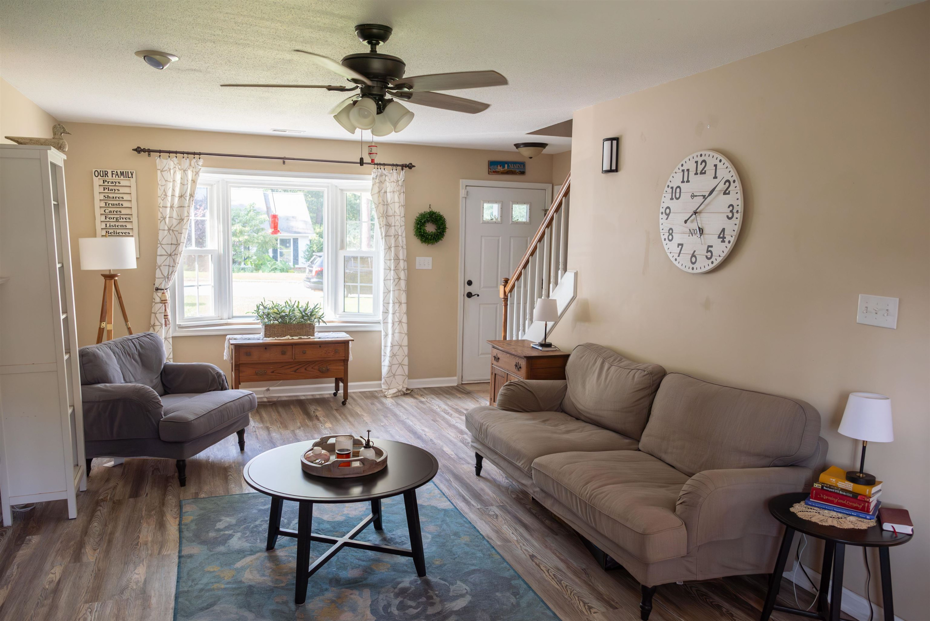 1301 Buckhorn Road Garner, NC 27529 - Photo 8 of 24 a living room with furniture a clock on wall and a window