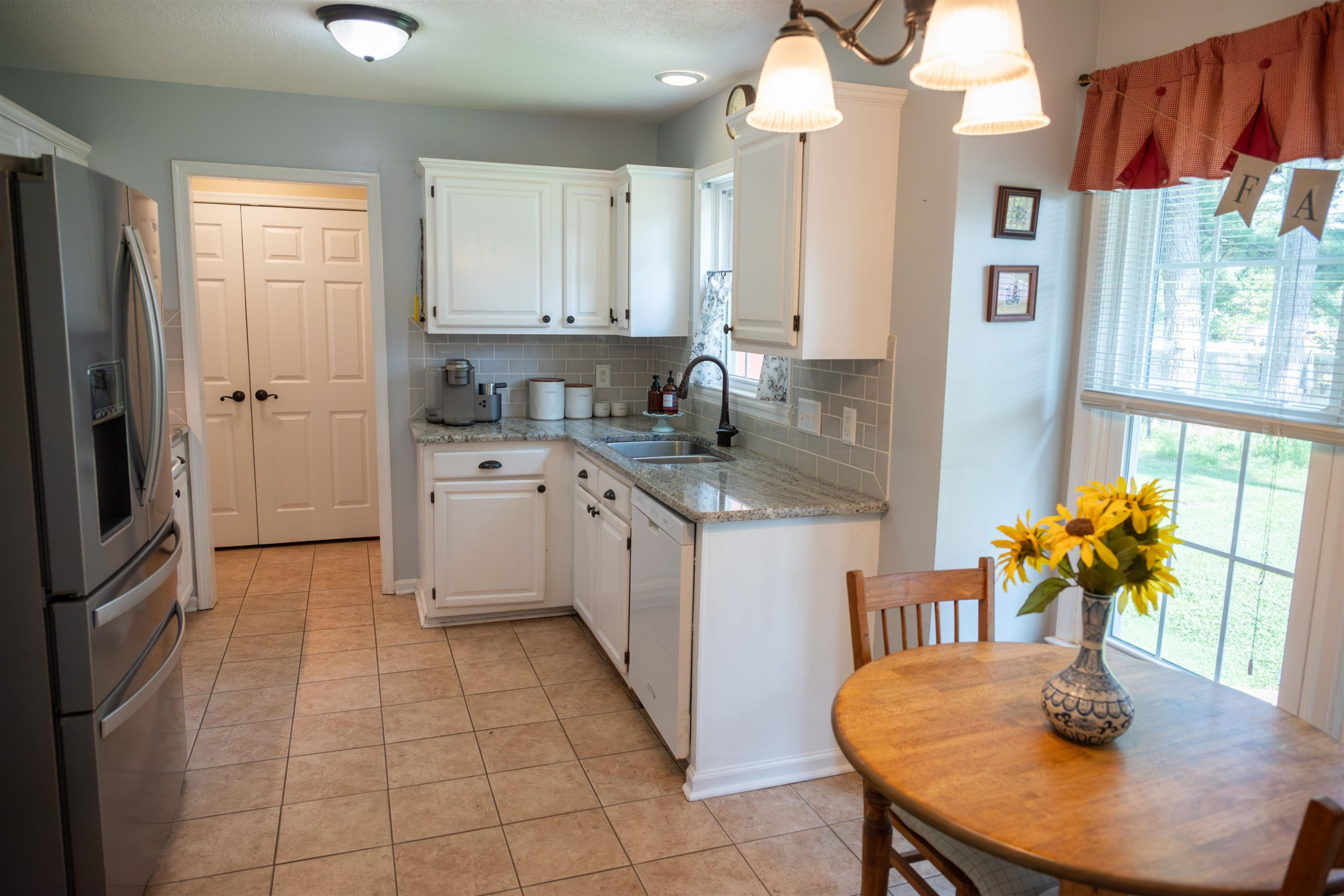 1301 Buckhorn Road Garner, NC 27529 - Photo 9 of 24 a kitchen with stainless steel appliances granite countertop a sink dishwasher and cabinets